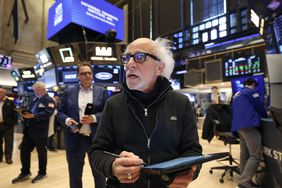 A trader works on the floor of the New York Stock Exchange (NYSE) at the opening bell on May 19, 2025, in New York City.