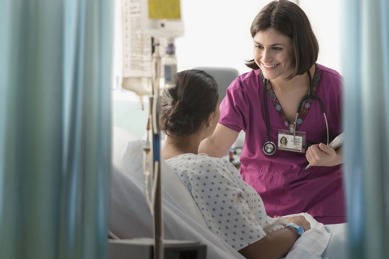 Nurse Talking to Patient in Hospital