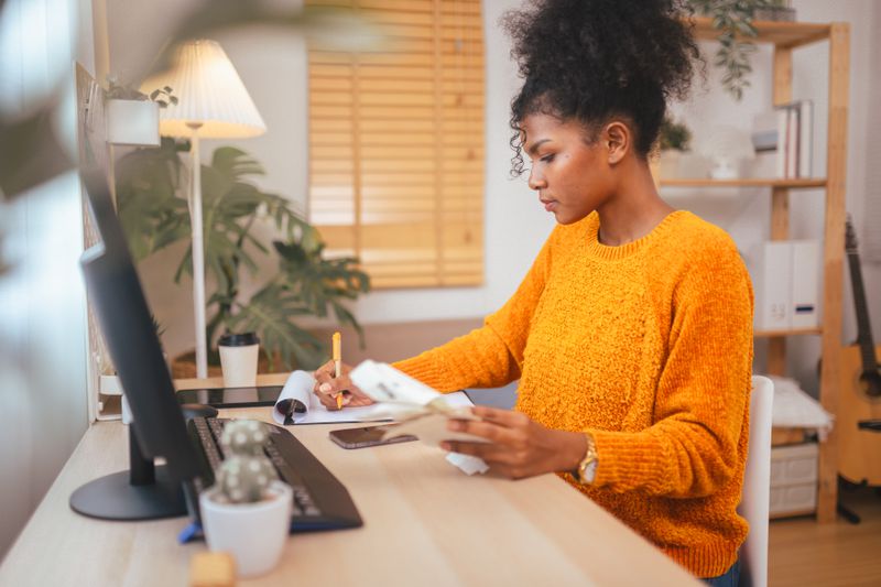 Young adult calculating budget and adjusting tax withholding for the year.