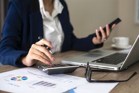 accountant at desk with calculator