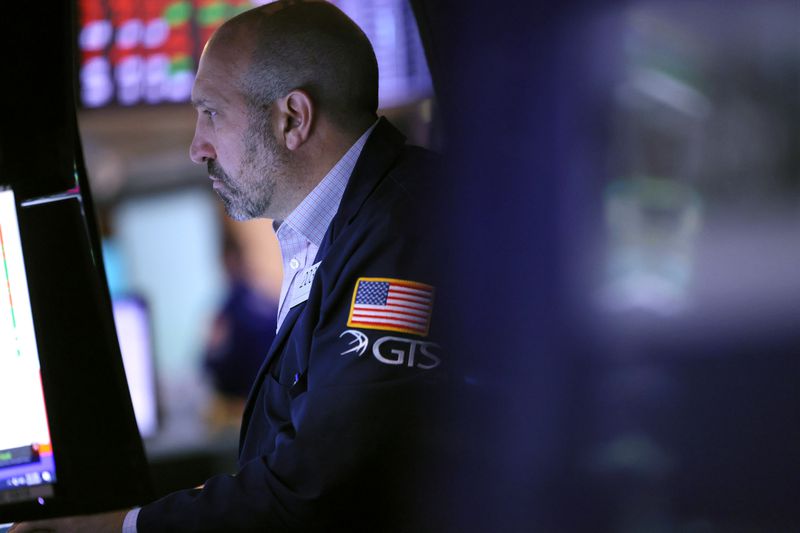 A trader looks at a computer screen while working on the floor of the New York Stock Exchange.