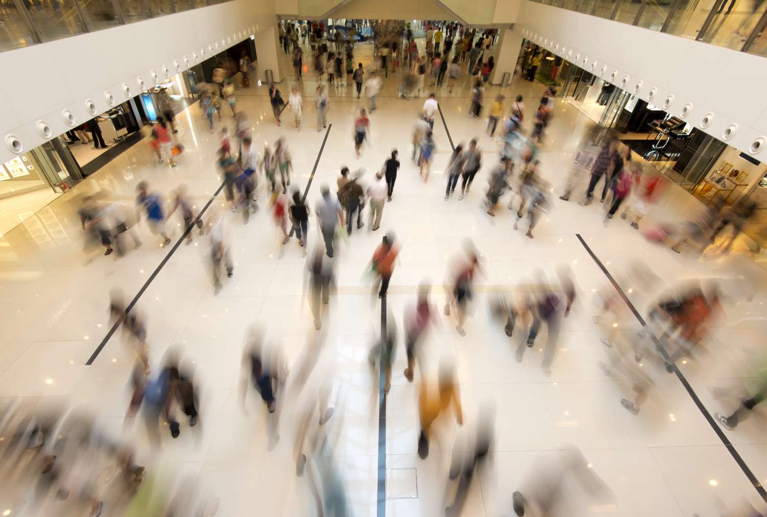 A photo illustration of blurred shoppers in a mall. 