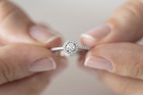 a woman's hands holding a diamond ring