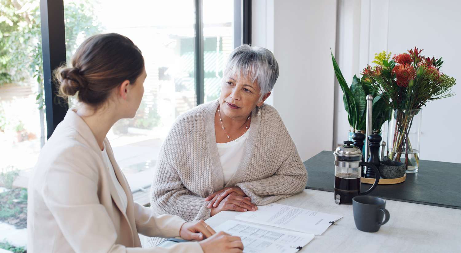Older woman discusses a prepaid tuition plan with her daughter