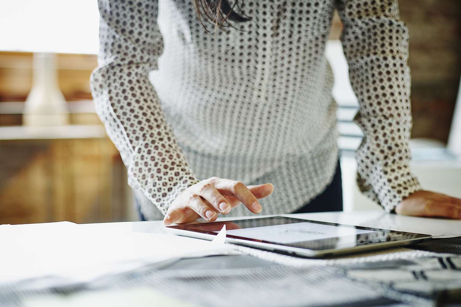 Businesswoman looking at business account on tablet in office