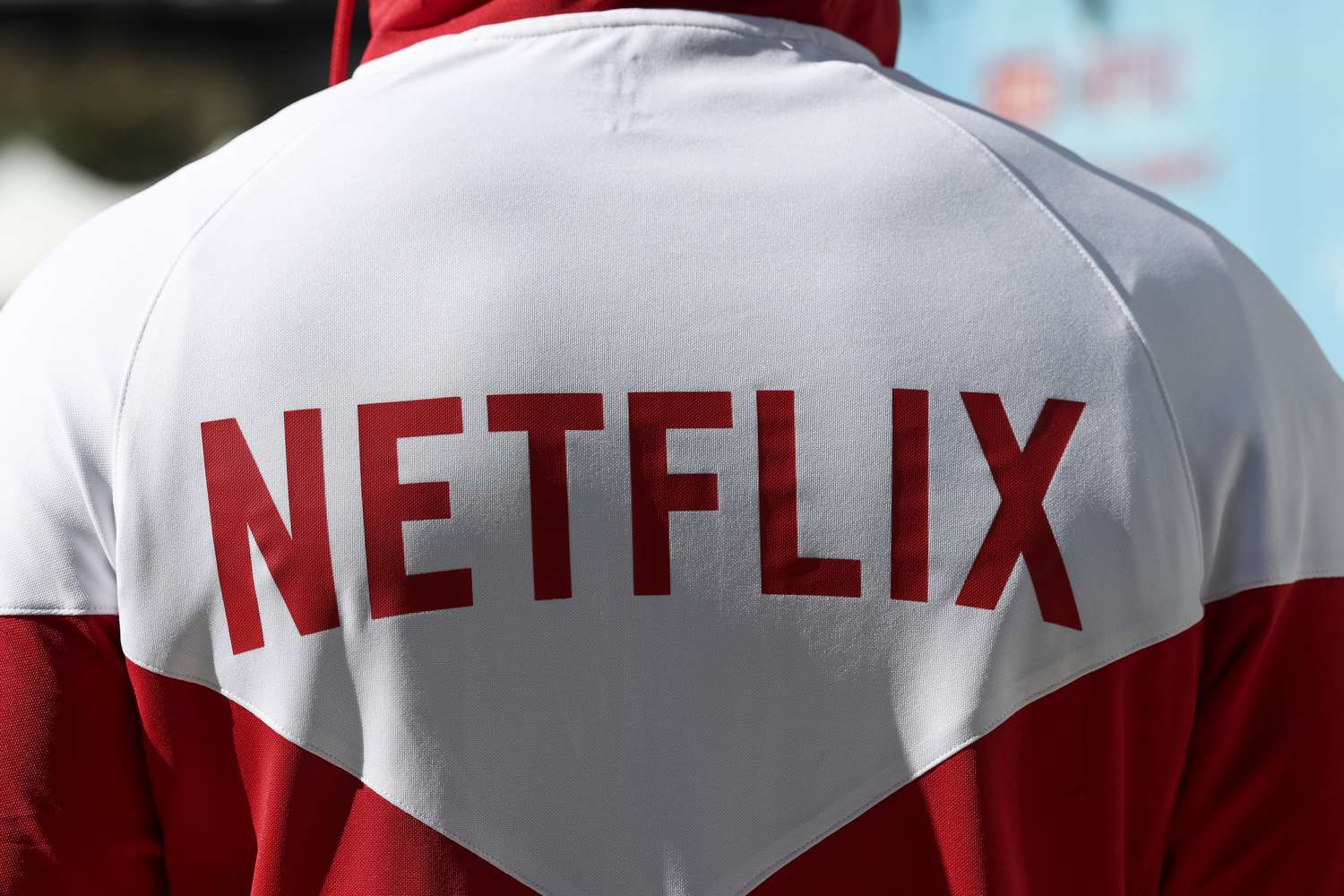 The Netflix logo is seen on the back of a red and white sweatshirt.