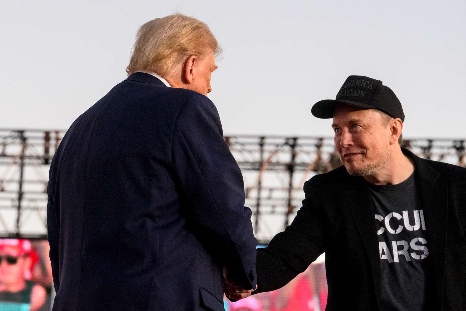 Donald Trump and Elon Musk shaking hands