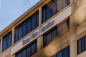 The exterior of an office building with the logo for Booz Allen Hamilton Holding Corporation on the outside.