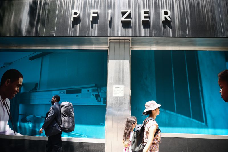 People pass by Pfizer World Headquarters in Manhattan, New York
