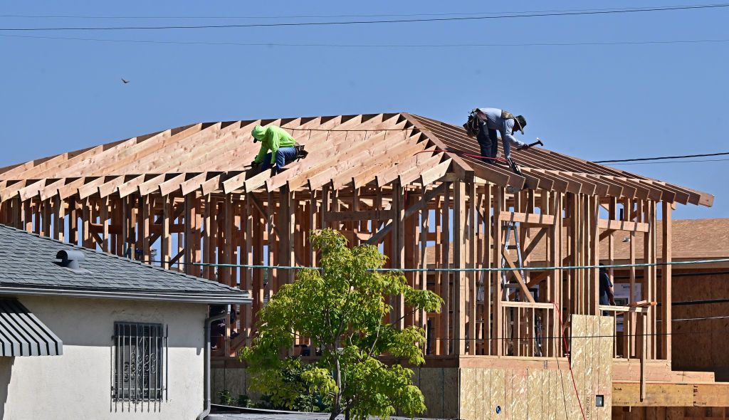 Construction workers work on the roof of a house being built in Alhambra, California on September 23, 2024. 