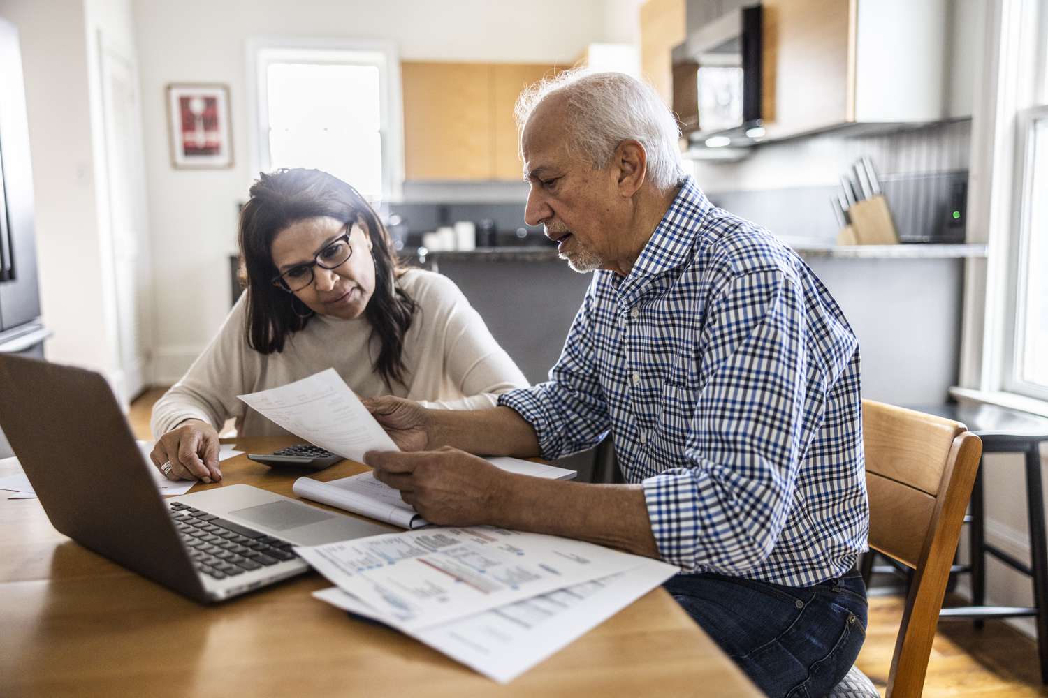 A senior couple paying bills at home