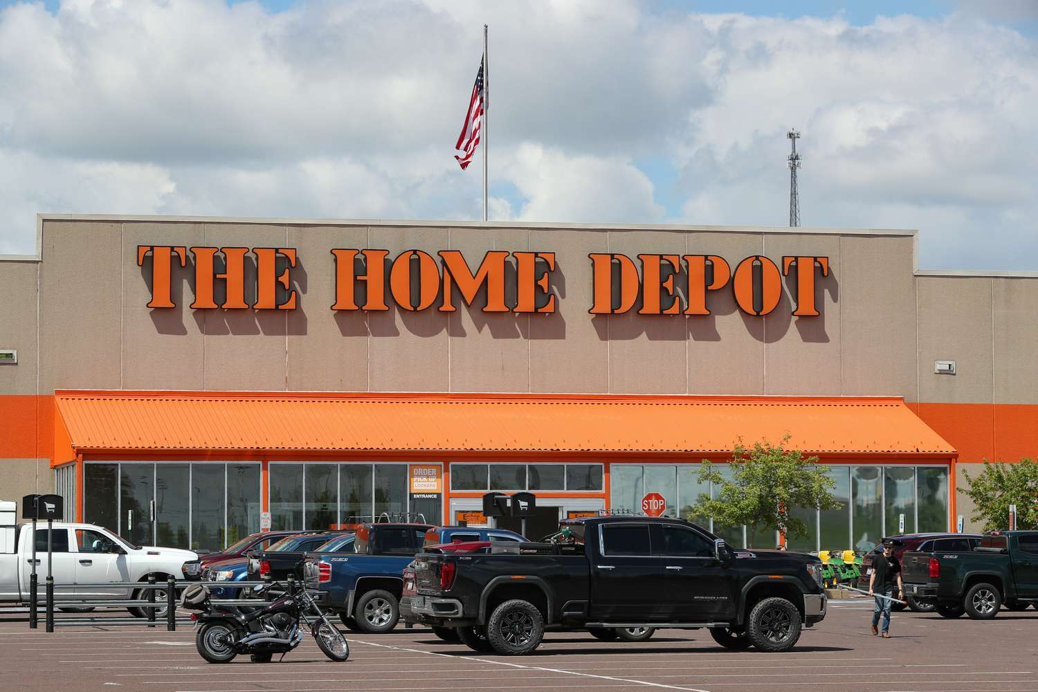 Cars are parked in front of a Home Depot store.