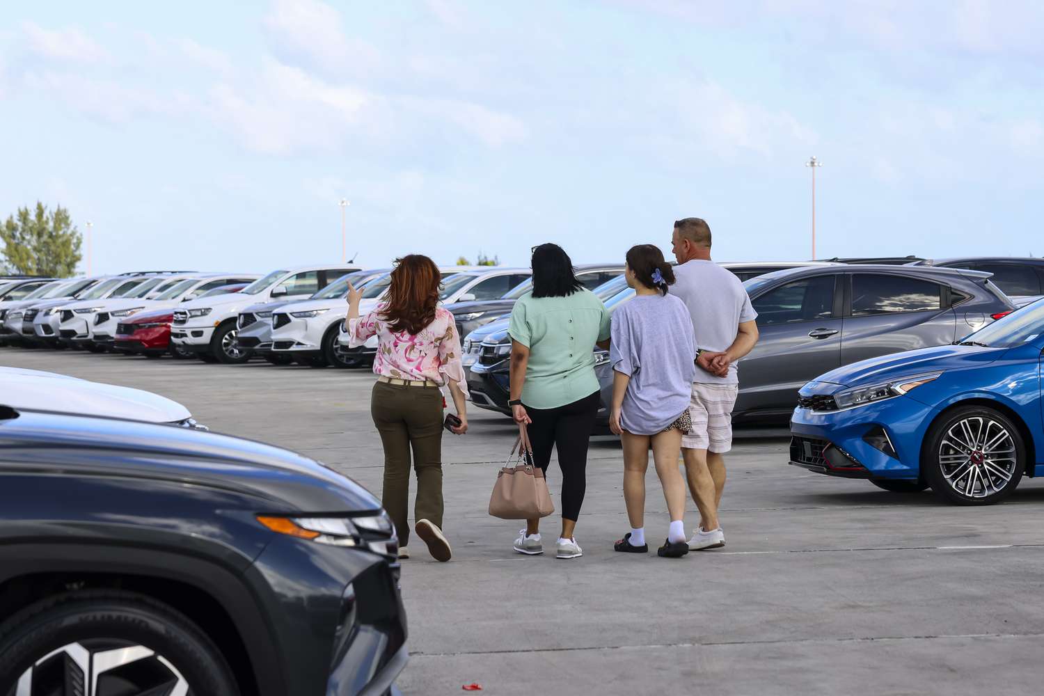 Customers view new vehicles displayed for sale at a Volkswagen AG (VW) dealership in Miami, Florida, US, on Saturday, April 5, 2025.