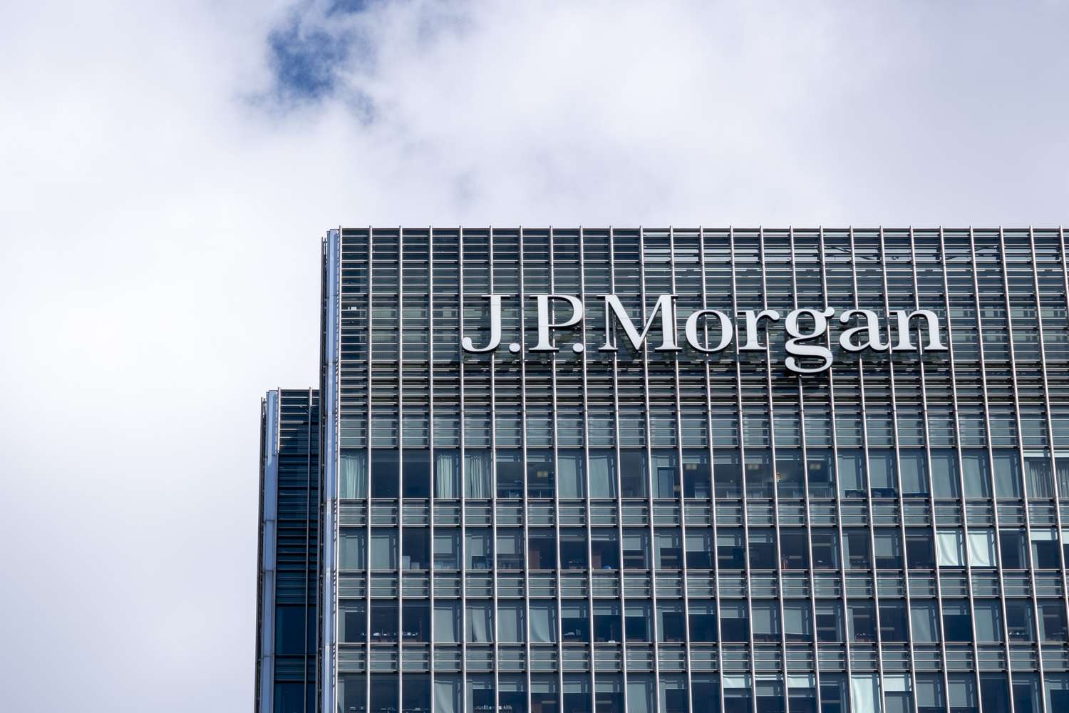 A J.P. Morgan sign appears on the company's headquarters in London. 