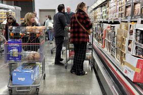 Customers shop for groceries at a Costco store in Novato, California