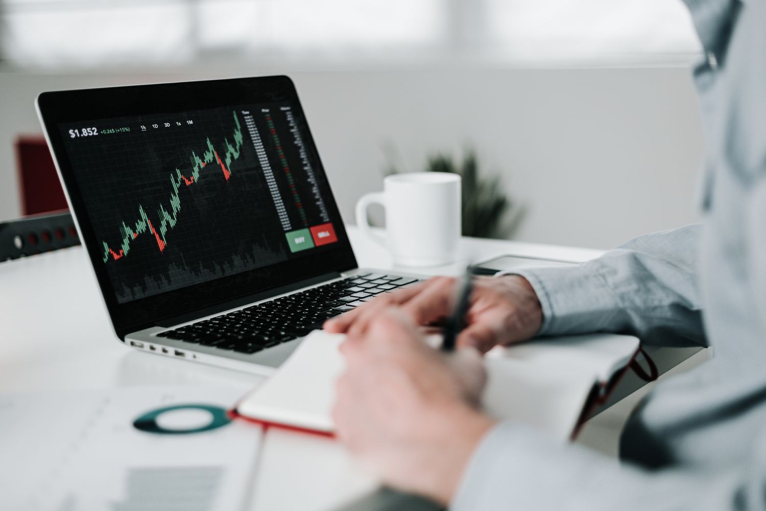 Young businessman using laptop for analyzing data stock market