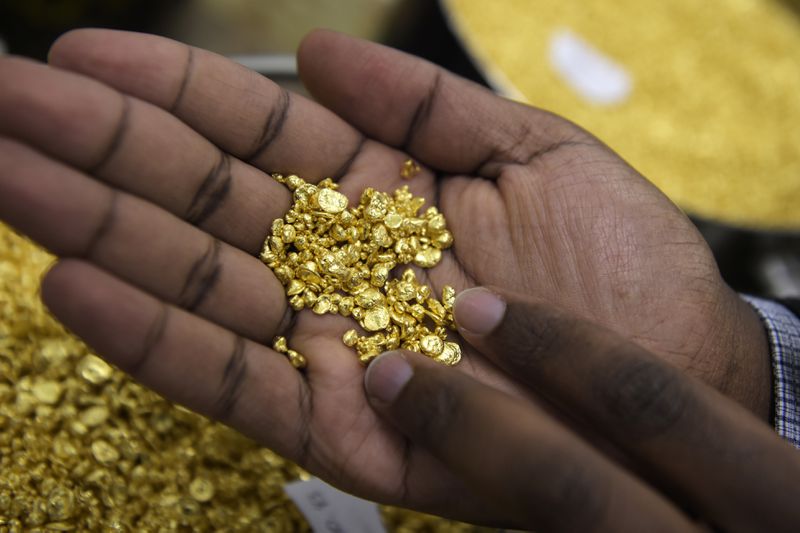 A person holding gold nuggets