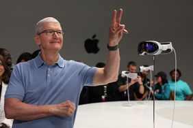 Apple CEO Tim Cook with an Apple Vision Pro display.