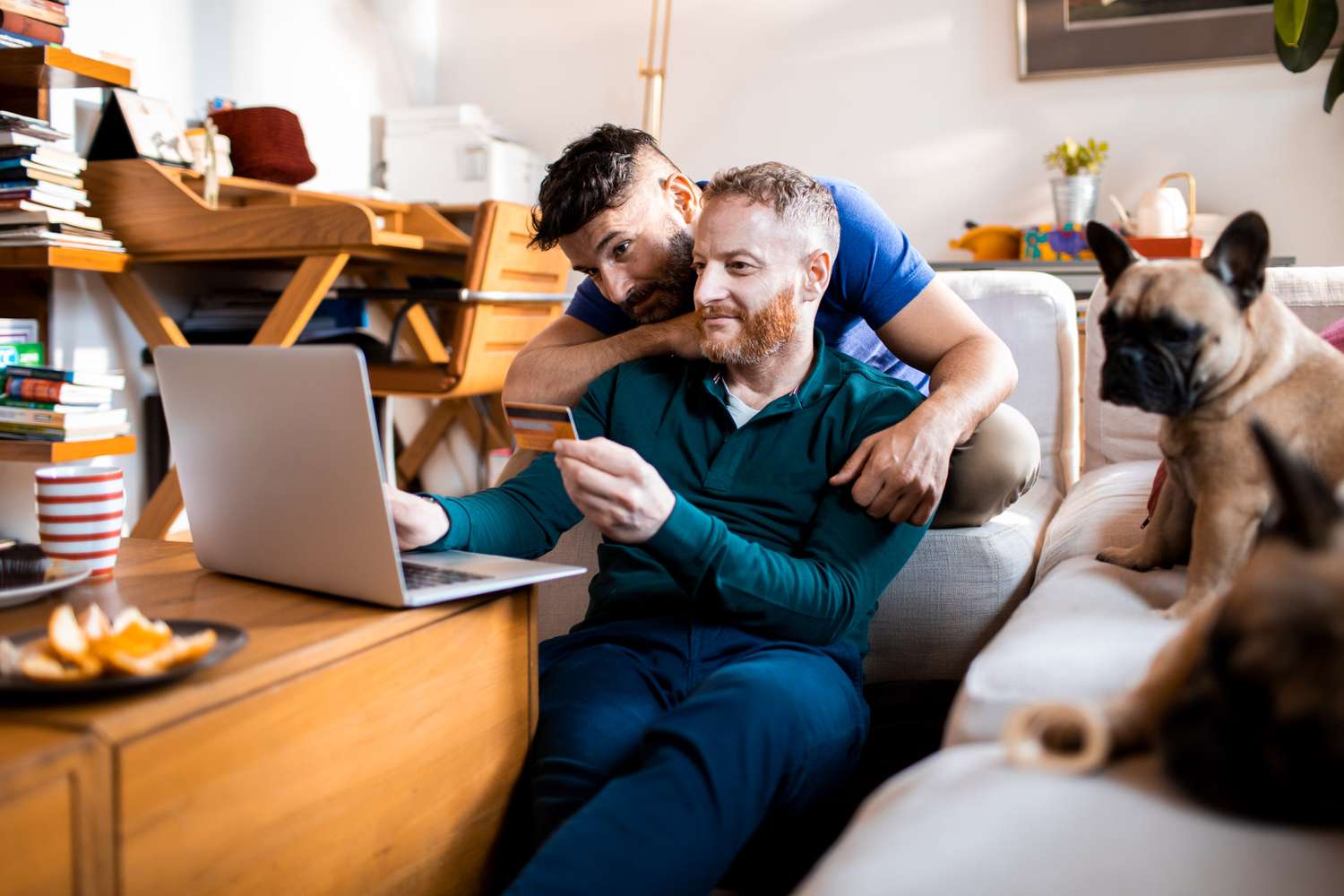 Close-up of a male couple shopping online on their laptop.