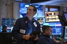 Traders work on the floor of the New York Stock Exchange.