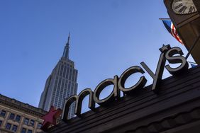 The Empire State Building behind a Macy's logo in New York City.