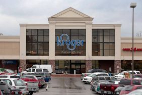 The parking lot of a Kroger store is full. 