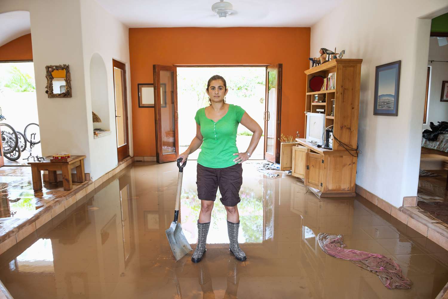 Woman cleaning the house after a flood.