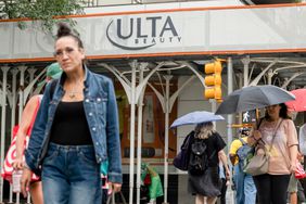 Passersby walk near an Ulta store.