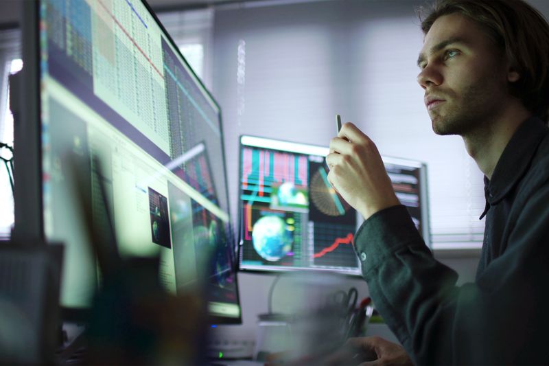 Stock analyst looking at market data
