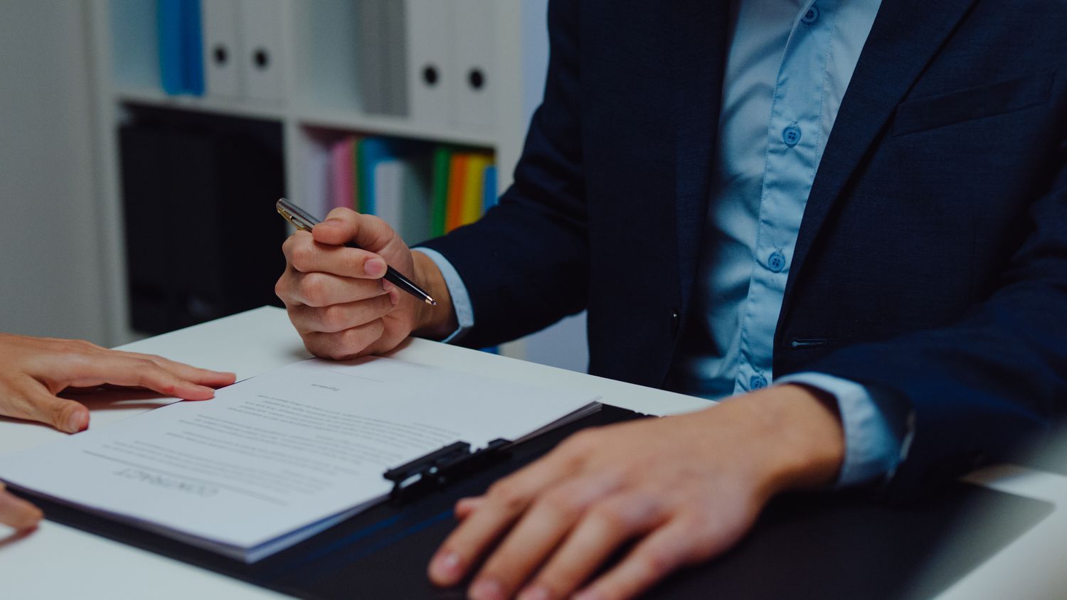A businessperson signing a document