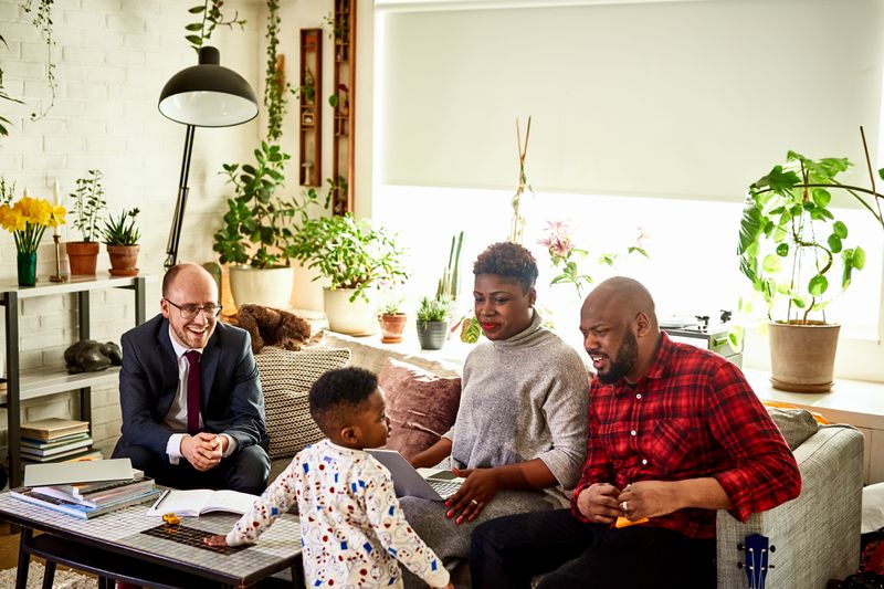 Parents with son discussing finances with advisor