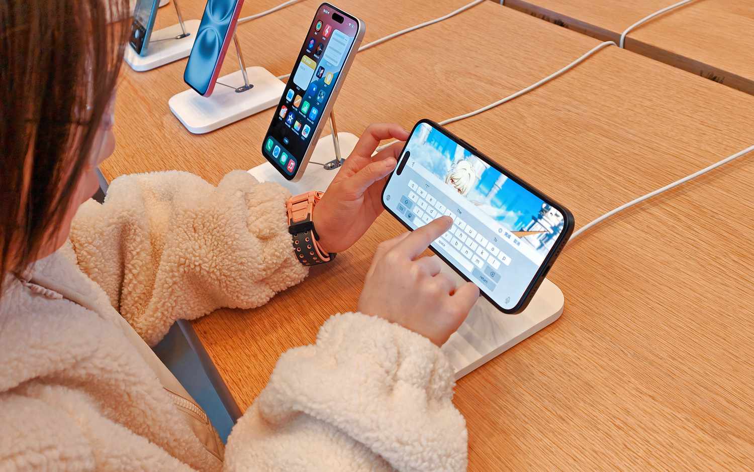 Person interacts with iPhone display.
