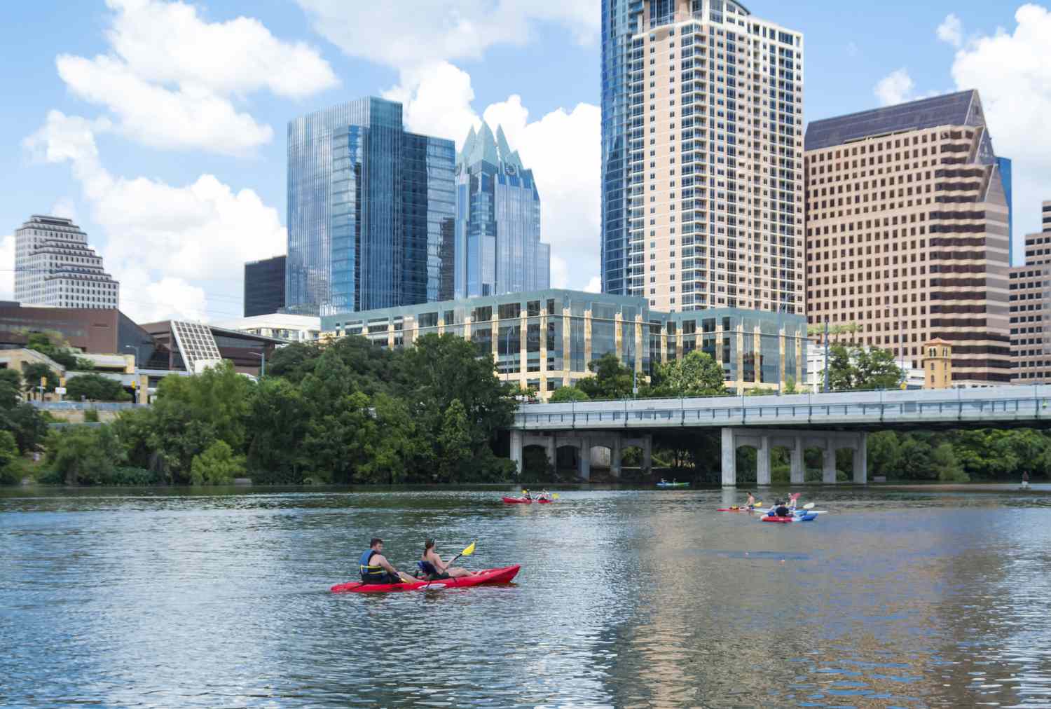 People kayak on Lady Bird Lake in Austin, Texas