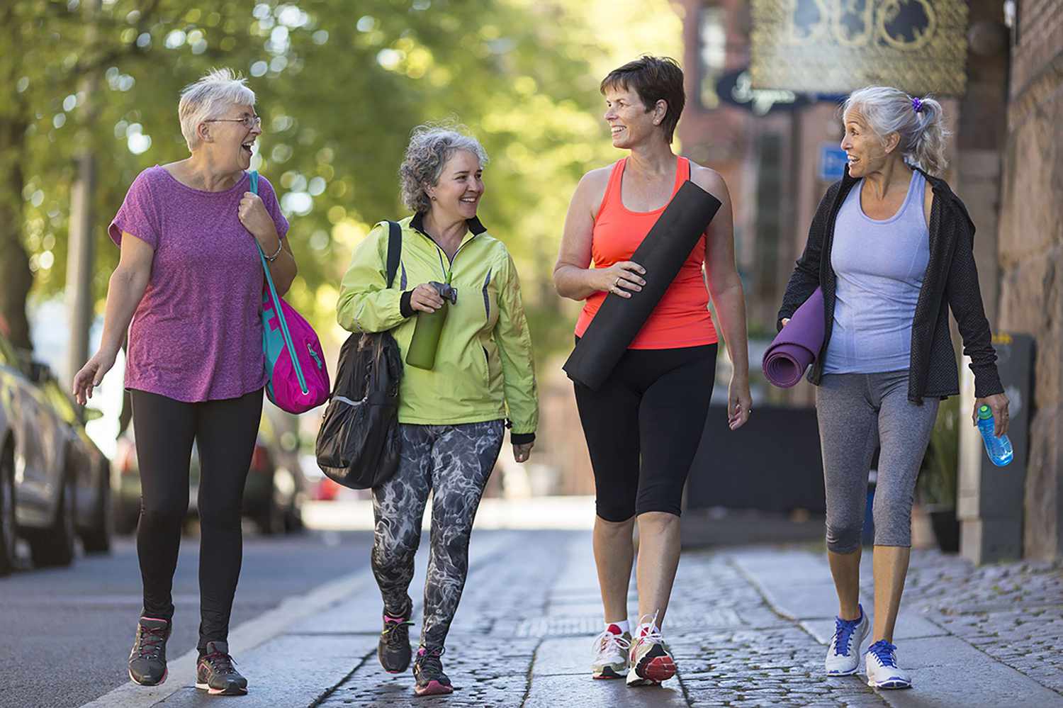Group of middle-aged and older women walking together in fitness clothing