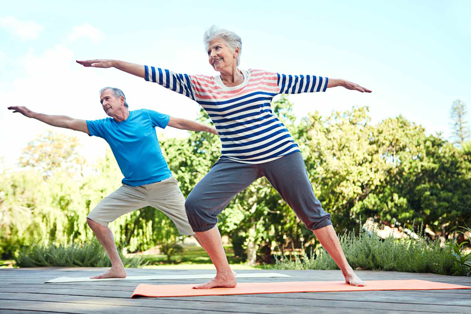 Senior couple doing yoga outside