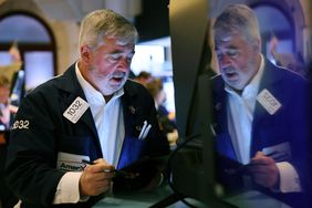 Traders work on the floor of the New York Stock Exchange.