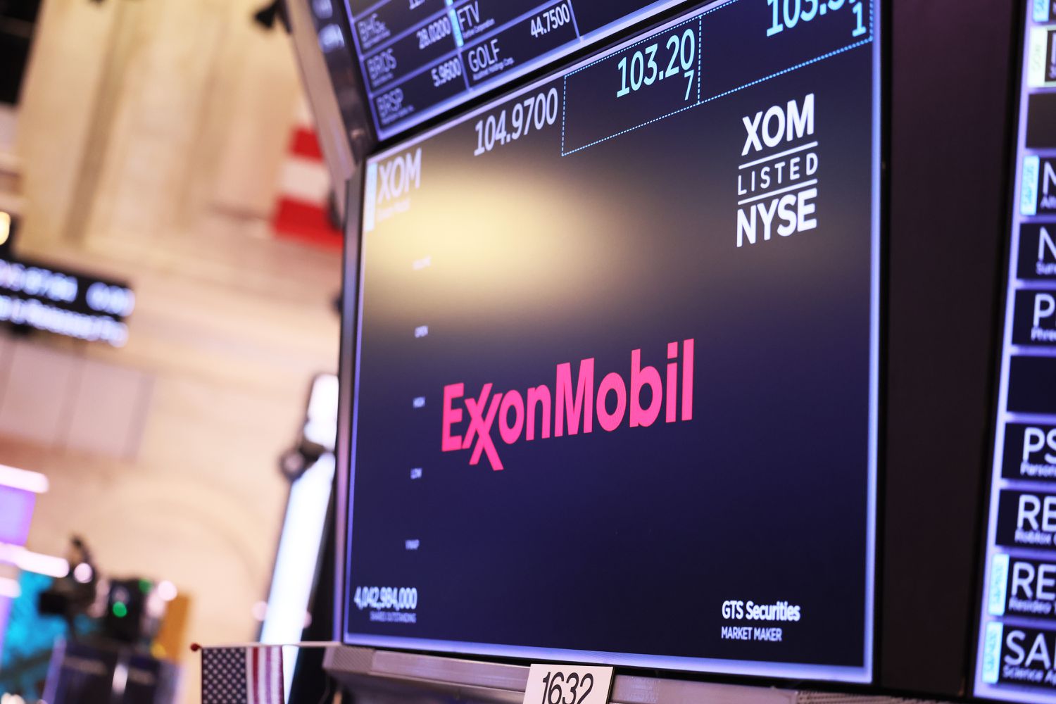 The ExxonMobil company logo is displayed as traders work on the floor of the New York Stock Exchange during morning trading on May 30, 2023 in New York City.