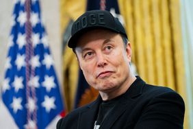 Elon Musk, wearing a black "DOGE" cap