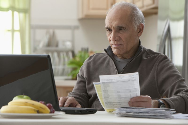 Man Paying Bills on Laptop