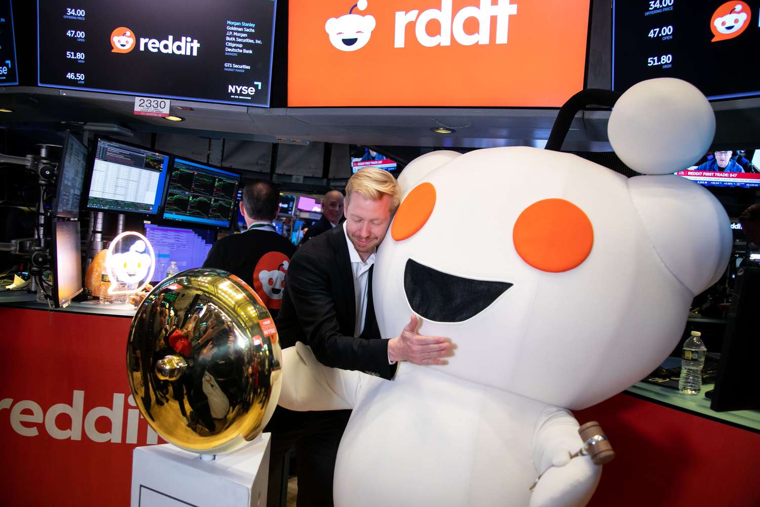 CEO Steve Huffman hugs Reddit mascot Snoo during the company's IPO at the New York Stock Exchange, on March 21, 2024.