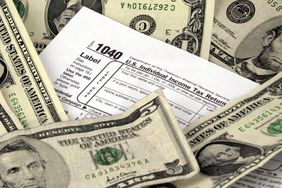 1040 Tax form surrounded by dollar bills