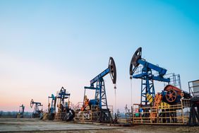 A row of oil pumps in an oil drilling field in Siberia. 