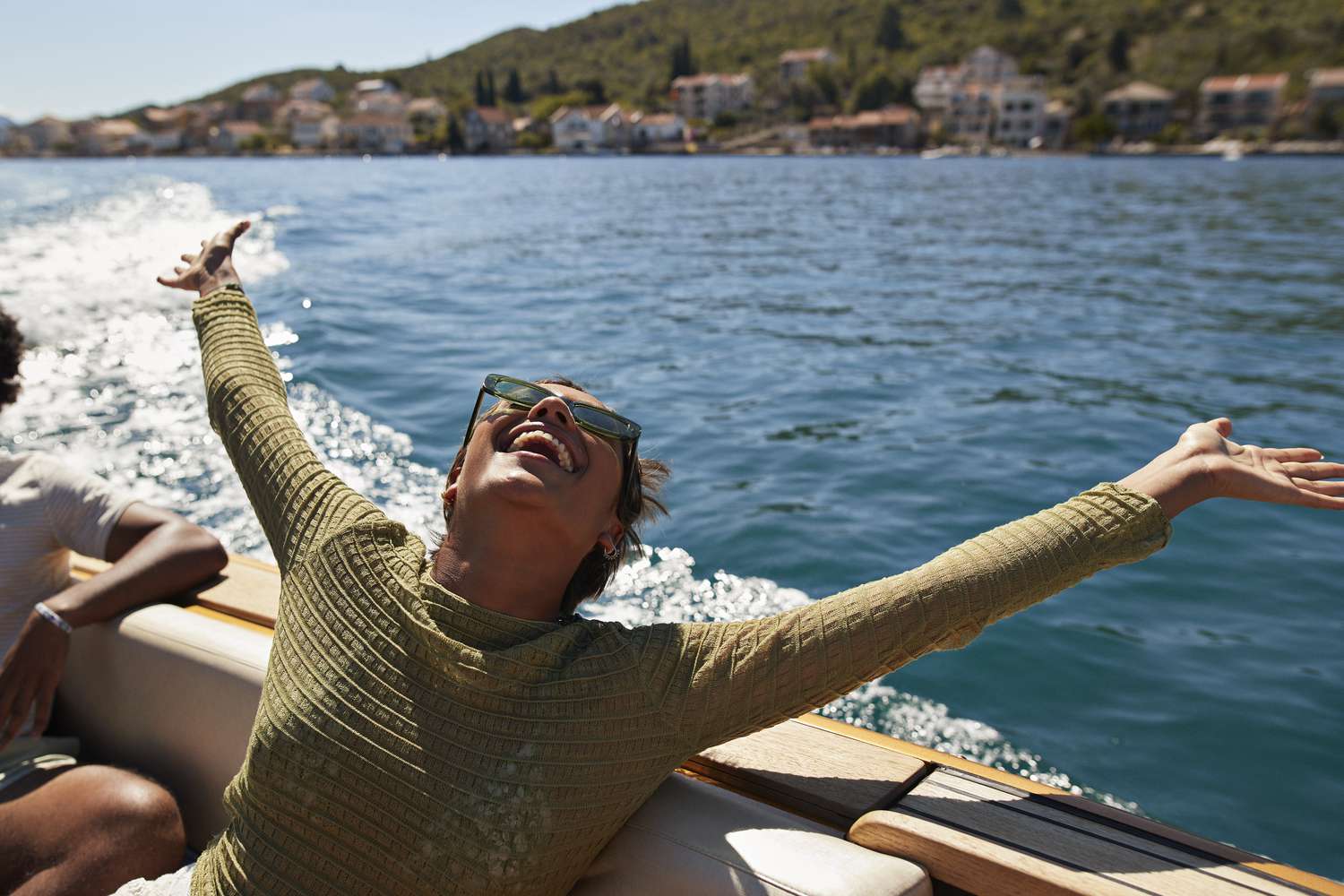 Happy young woman in a motorboat during a sunny day