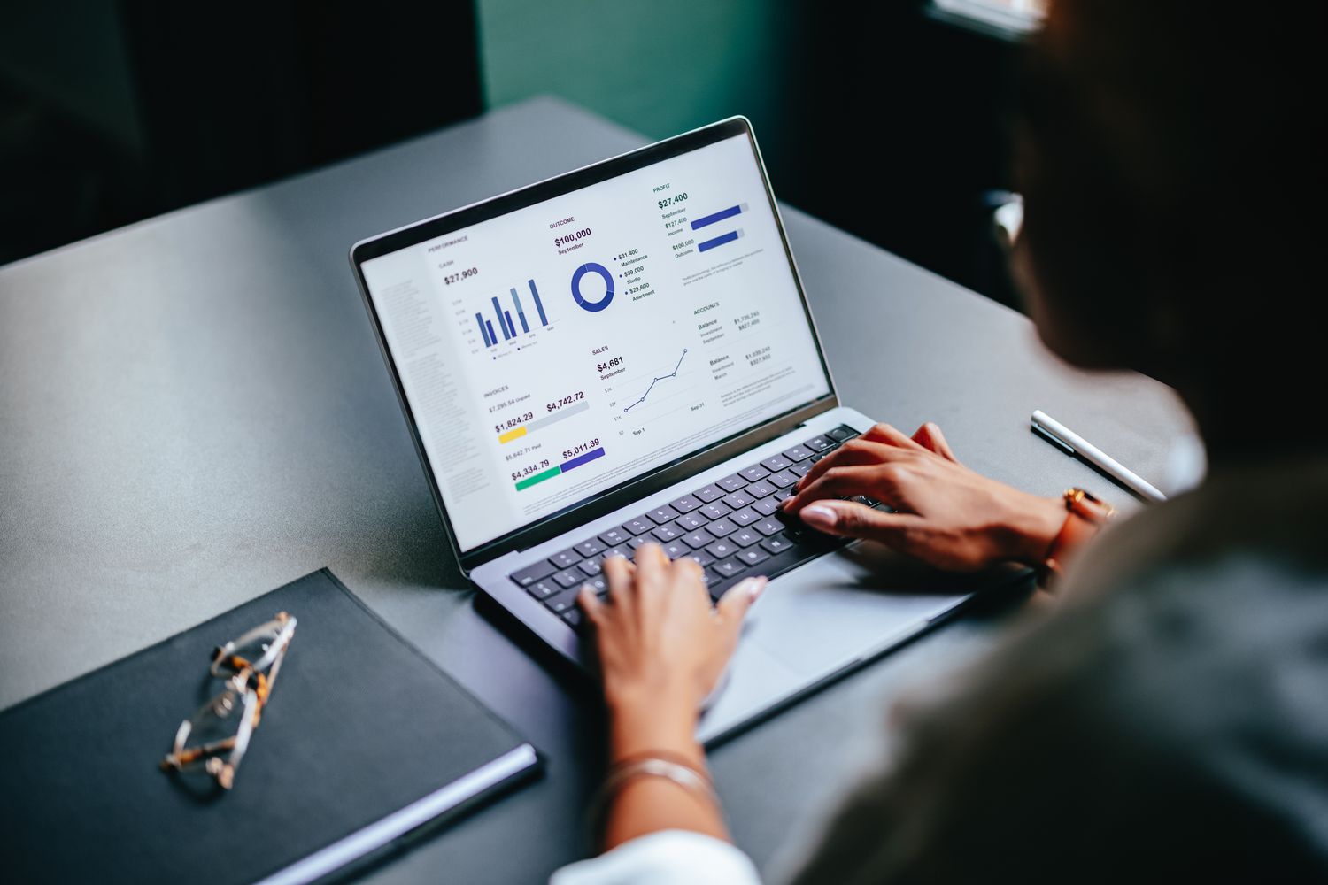 An investor reviews the growth in the balance of their retirement account using a small laptop.