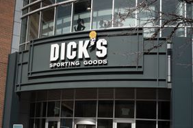 The Dick's Sporting Goods logo is seen above the entrance to a store.