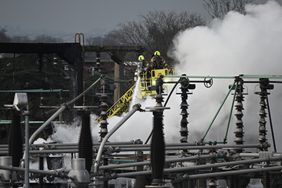 Members of the fire brigade attend the scene after a major fire at an electrical substation at Heathrow airport. 