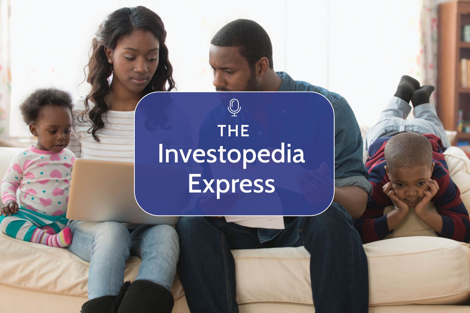 African American family sitting on the couch with a laptop discussing finances