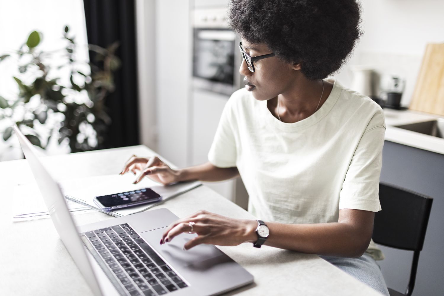 A woman with a calculator and a computer