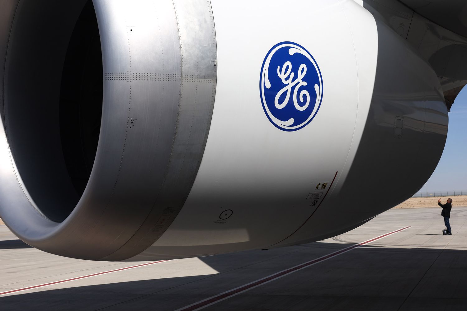 A General Electric logo on the engine of a passenger aircraft.