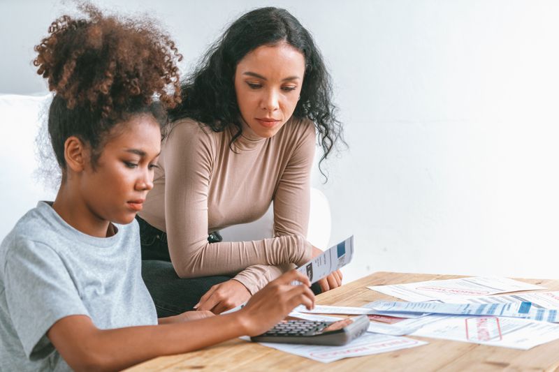 Mom teaching her daughter about finances.
